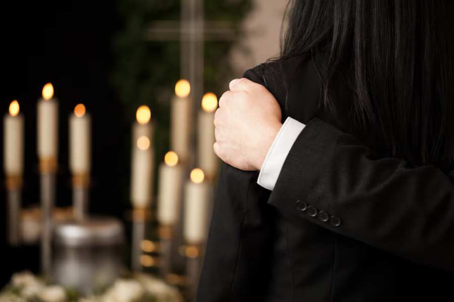 people-funeral-consoling-each-other