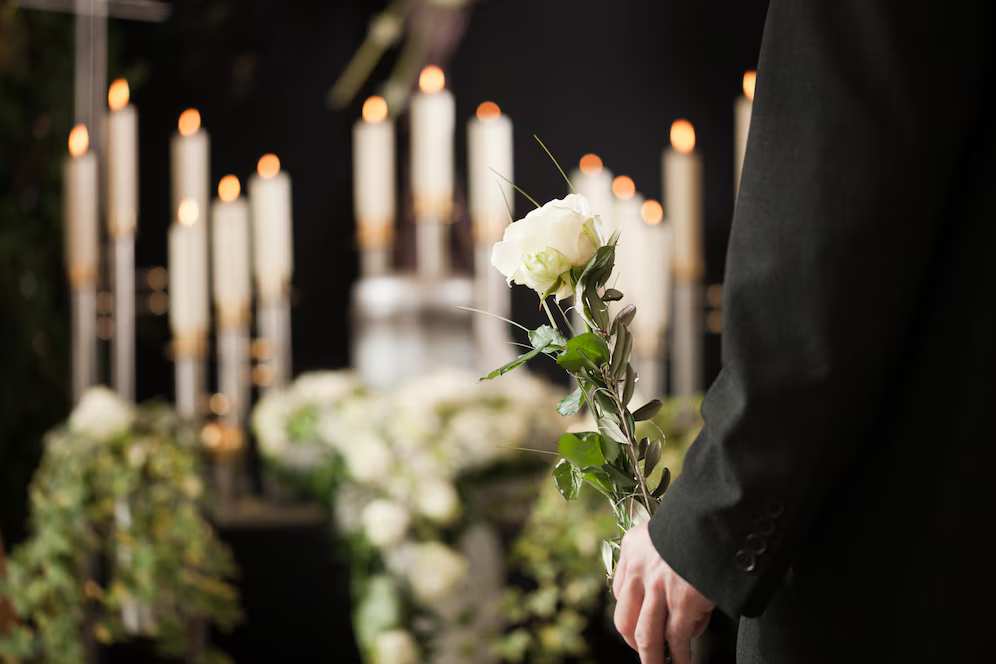 woman-holding-white-flower-funeral woman-holding-white-flower-funeral